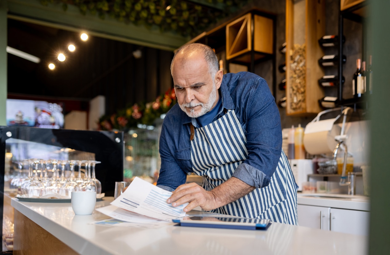 Latin American business manager bookkeeping at a cafe